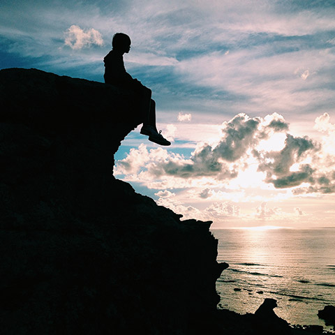 A silhouette of a boy with a view to remember